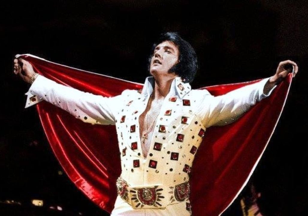 “From Karate Kicks to Rhinestone Glory: The Untold Story Behind Elvis Presley’s Jumpsuits – How a Bold Fashion Gamble Became the King’s Ultimate Stage Weapon, Why His Tailor Protected His Masculinity at All Costs, and the Hidden Symbolism Sewn into Every Stitch” “From Karate Kicks to Rhinestone Glory: The Untold Story Behind Elvis Presley’s Jumpsuits – How a Bold Fashion Gamble Became the King’s Ultimate Stage Weapon, Why His Tailor Protected His Masculinity at All Costs, and the Hidden Symbolism Sewn into Every Stitch”